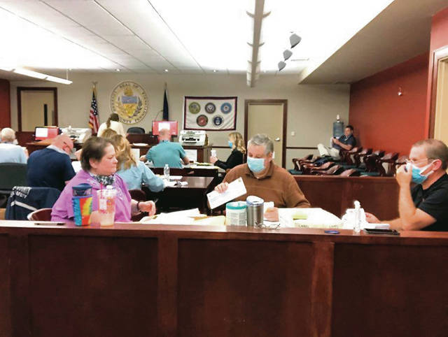 Angela Scocozzo, left, together with Carl Lisowski and David Skoronski help process mail-in ballots Tuesday night at Luzerne Countys Penn Place building in Wilkes-Barre.
                                 Kevin Carroll | Times Leader