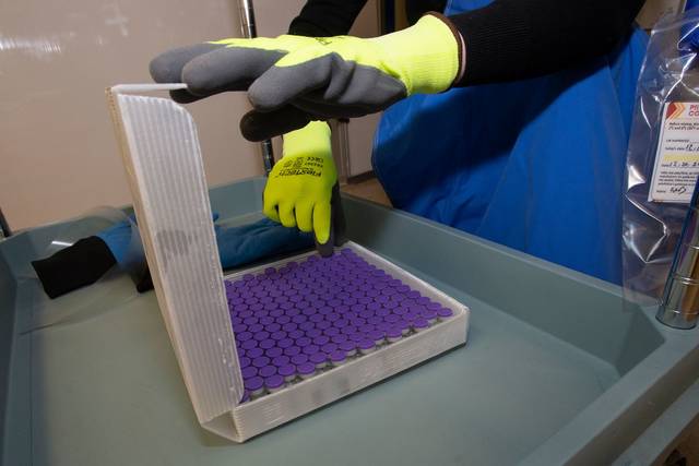 <p>Kelly Bolesta, director of pharmacy services, counts the vials of the Pfizer COVID-19 vaccine delivered Tuesday to Geisinger Wyoming Valley Medical Center.</p>
<p>Courtesy of Geisinger</p>