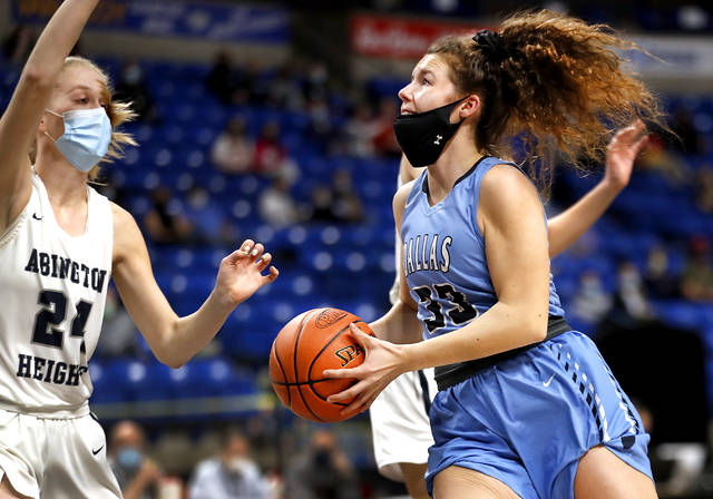 Dallas forward Claire Charlton drives toward the basket as Abington Heights Allison Dammer guards during the District 2 Class 5A championship game at Mohegan Sun Arena on Saturday.
Fred Adams | for Times Leader