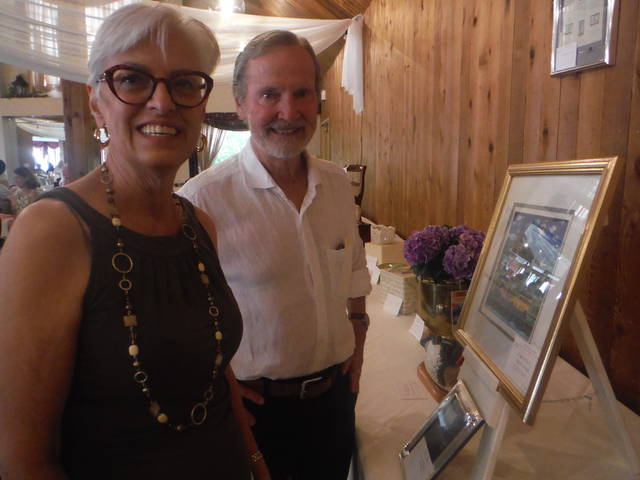 <p>Connie and Durelle Scott of Dallas look over some of the auction items that were on display at Apple Tree Terrace at Newberry Estates, where the Back Mountain Memorial Library Auction’s kick-off dinner was held Monday evening.</p>
<p>Mary Therese Biebel | Times Leader</p>