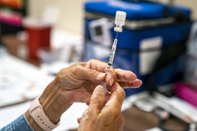 127729738_web1_127729738-29a646a3a0ef4c33b05cdd93059327a9
A vaccine provider prepares a dose of the COVID-19 vaccine at a clinic run by the Allegheny County Health Department at Casa San Jose, a non-profit serving Latino immigrants, Tuesday, September 14 in the Beechview neighborhood of Pittsburgh. The proportion of COVID-19 infections and hospitalizations among vaccinated Pennsylvania residents rose sharply last month, reflecting the fact that a higher percentage of the population has now gotten the shot but also likely that protection has waned somewhat, state health officials said Friday.
Alexandra Wimley | Pittsburgh Post-Gazette via AP
