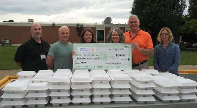 130650944_web1_arp1
Tracey Selingo, Fork Over Loves founder and CEO, third from right, accepts a ceremonial check last week for Luzerne Countys $500,000 American Rescue Plan donation. Standing with her, from left, are: Steve Glasson, volunteer; Nik Hughes, Jonathans Restaurant manager; LeeAnn McDermott, county councilwoman; Brian Thornton, council vice chairman; and Michele Sparich, county grants writer.
Jennifer Learn-Andes | Times Leader