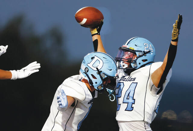 131780364_web1_wba_dal3_faa
Dallass Logan Geskey holds the ball up in the end zone after recovering a fumble by tailback Mark Saracinaj for the touchdown in the first quarter.
Fred Adams | For Times Leader