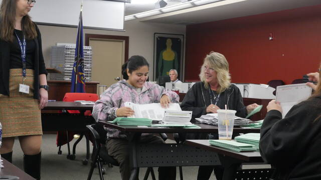 <p>Temporary Luzerne County election worker Nancy Galeno, seated at left, and county Voting System Specialist Denise Shimko prepare accepted general election provisional ballots for tallying during Thursday’s adjudication as county Election Director Emily Cook, standing at left, supervises.</p>
<p>Jennifer Learn-Andes | Times Leader</p>