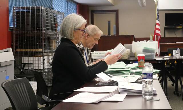 <p>Luzerne County Election Board Chairwoman Christine Boyle, at left, and member Daniel Schramm unseal approved provisional ballots during Thursday’s public general election adjudication. </p>
<p>Jennifer Learn-Andes | Times Leader</p>