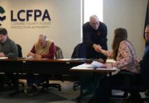 
			
				                                Luzerne County Flood Protection Authority Board member Jay Delaney (standing) congratulates Laura Holbrook Tuesday on her promotion to the authority executive director position. Seated, from left, are Authority Chairman Dominic Yannuzzi, Authority Board member Coray Mitchell and Authority Solicitor Christopher Slusser.
                                 Jennifer Learn-Andes | Times Leader

			
		