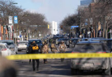 
			
				                                Federal agents stand near the site of a shooting on Jan. 24 in Minneapolis.
                                 AP Photo

			
		