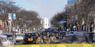 
			
				                                Federal agents stand near the site of a shooting on Jan. 24 in Minneapolis.
                                 AP Photo

			
		