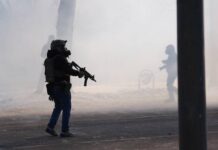 
			
				                                Federal immigration officers deploy tear gas after a shooting in Minneapolis on Jan. 24.
                                 AP Photo

			
		